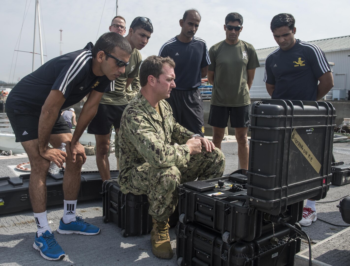 A U.S. Navy Explosive Ordnance Disposal technician assigned to EOD Mobile Unit 11 explains an unmanned underwater vehicle system to Indian EOD technicians during exercise Malabar 2016. A trilateral maritime exercise, Malabar is designed to enhance dynamic cooperation between the Indian Navy, Japan Maritime Self-Defense Force (JMSDF) and U.S. Navy forces in the Indo-Asia-Pacific. (U.S. Navy combat camera photo by Mass Communication Specialist 1st Class Charles E. White/Released)