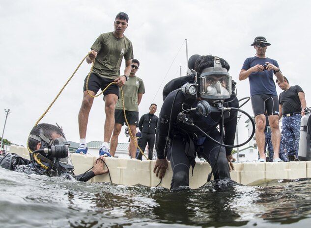 An Indian Explosive Ordnance Disposal (EOD) technician enters the water during a training dive as part of exercise Malabar 2016. A trilateral maritime exercise, Malabar is designed to enhance dynamic cooperation between the Indian Navy, Japan Maritime Self-Defense Force (JMSDF) and U.S. Navy forces in the Indo-Asia-Pacific. (U.S. Navy combat camera photo by Mass Communication Specialist 1st Class Charles E. White/Released)