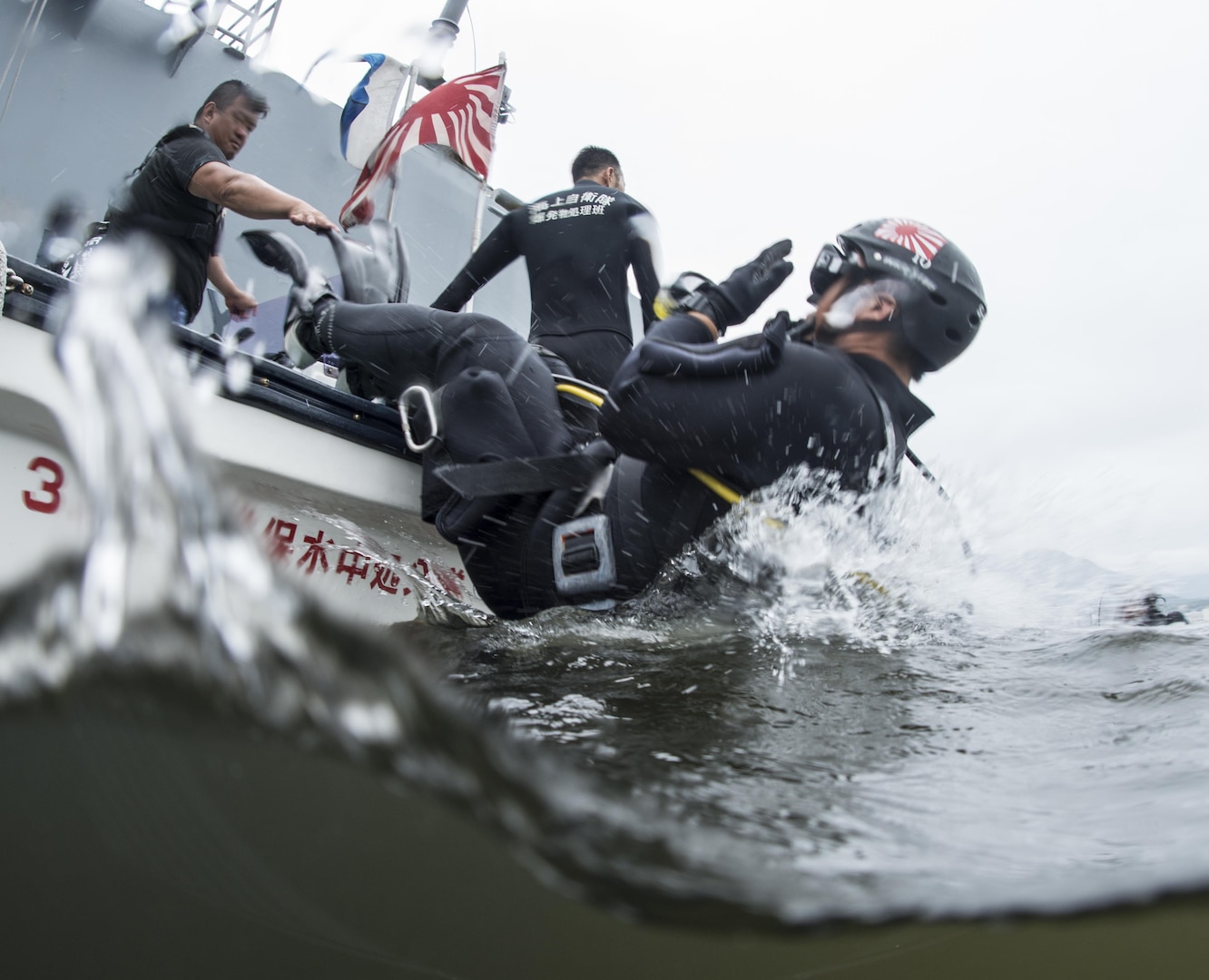 SASEBO, Japan (June 12, 2016) - A Japan Maritime Self-Defense Force (JMSDF) Explosive Ordinance Disposal technician enters the water in preparation for a dive under the guided-missile cruiser USS Mobile Bay (CG 53) at U.S. Fleet Activities Sasebo during exercise Malabar 2016, June 12.  A trilateral maritime exercise, Malabar is designed to enhance dynamic cooperation between the Indian Navy, JMSDF and U.S. Navy forces in the Indo-Asia-Pacific. 

(U.S. Navy photo by Mass Communication Specialist 1st Class Charles E. White/ Released)