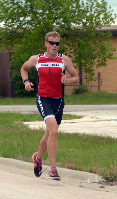 First Lt. Corey Hayes, 28th Force Support Squadron food service officer, runs in a triathlon at Ellsworth Air Force Base, S.D., May 21, 2016. He completed a 750-meter swim, 12-mile bike ride and 5k run, winning first place in his category. (U.S. Air Force photo by Airman Donald Knechtel/Released) 

