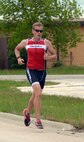 First Lt. Corey Hayes, 28th Force Support Squadron food service officer, runs in a triathlon at Ellsworth Air Force Base, S.D., May 21, 2016. He completed a 750-meter swim, 12-mile bike ride and 5k run, winning first place in his category. (U.S. Air Force photo by Airman Donald Knechtel/Released) 

