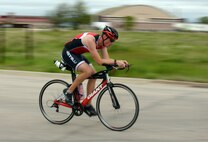 First Lt. Corey Hayes, 28th Force Support Squadron food service officer, endures the biking portion of a triathlon at Ellsworth Air Force Base, S.D., May 21, 2016. Being a big proponent of physical fitness, Hayes avidly participates in triathlons such as these to inspire others to set goals and work towards them. (U.S. Air Force photo by Airman Donald Knechtel/Released) 