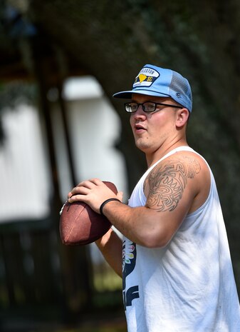 Airman 1st Class Evan Hittle, a 437th a 437th Aircraft Maintenance Squadron instrument and flight control systems specialist, prepares to throw a football at Joint Base Charleston, June 9, 2016. Hittle played high school football and still enjoys playing with friends in his free time. (U.S. Air Force Photo/Airman Megan Munoz)