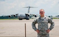 Airman 1st Class Evan Hittle, a 437th Aircraft Maintenance Squadron instrument and flight control systems specialist, stands in front of a C-17 Globemaster III aircraft at Joint Base Charleston, June 11, 2016. Hittle was five-years-old and his sister was seven when their parents passed away and they were orphaned in the Ukraine. A few years later, Hittle and his sister were adopted in the U.S. and transitioned to a new life. Hittle now plans to make the U.S. Air Force a career. (U.S. Air Force Photo/Airman Megan Munoz)