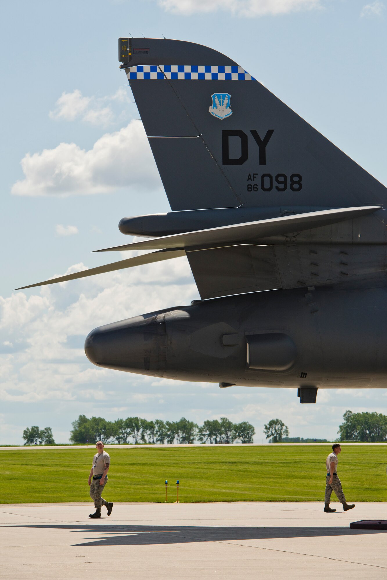 Team Minot Airmen observe a B-1B Lancer from Dyess Air Force Base, Texas, as it sits at Base Operations at Minot AFB, N.D., June 3, 2016. Aircraft from around Air Force Global Strike Command visited Minot for the 5th Bomb Wing change of command. (U.S. Air Force photos/Airman 1st Class J.T. Armstrong)
