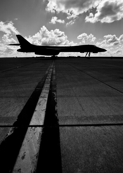 A silhouetted B-1B Lancer from Dyess Air Force Base, Texas sits at Base Operations at Minot AFB, N.D., June 3, 2016. Aircraft from around Air Force Global Strike Command visited Team Minot for the 5th Bomb Wing change of command. (U.S. Air Force photos/Airman 1st Class J.T. Armstrong)