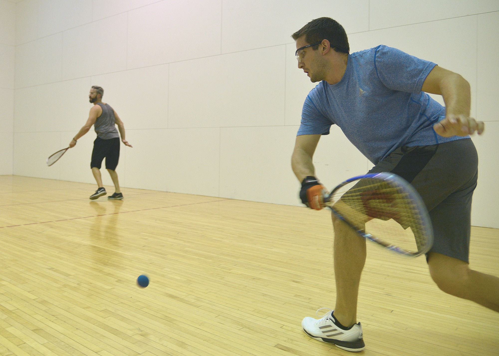 Sean Anderson, right, and Casey Link, employees of the Defense Contract Management Agency at Kirtland, play a competitive game of racquetball at the Fitness Center courts. The base is introducing a new racquetball challenge league, to run through the summer months. (Photo by Todd Berenger)