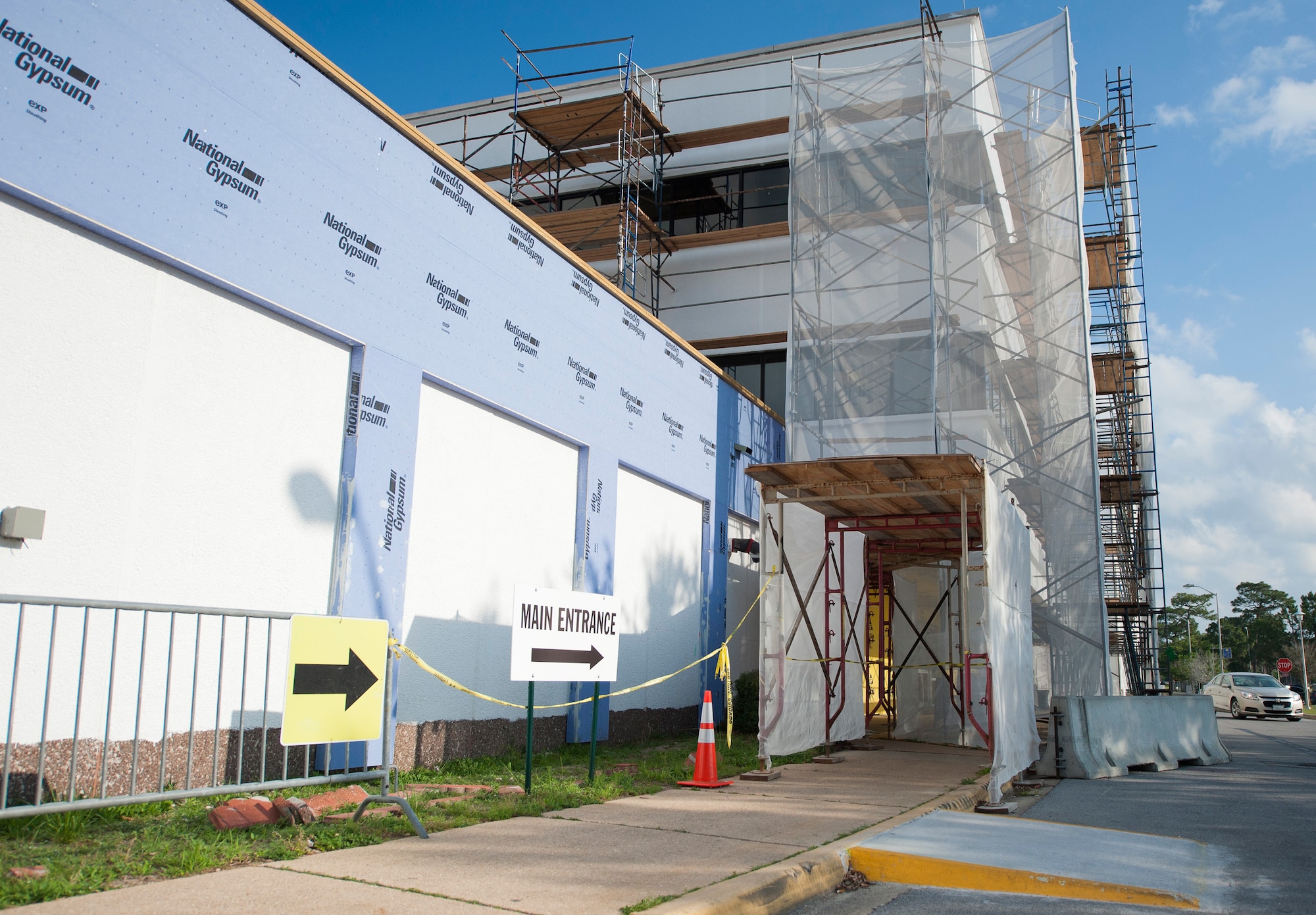 Eglin hospital’s main entrance wrapped in construction scaffolding due to an exterior overhaul. The renovations will update and improve the 50-year-old structure. (U.S. Air Force photo/Ilka Cole) 
