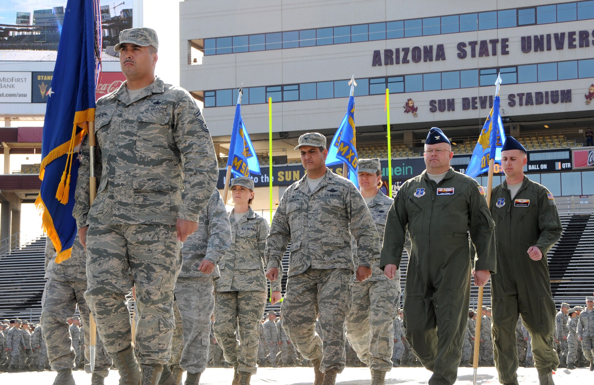 Senior Master Sgt. Alex brown, front, leads the Arizona Air National Guard’s 161st Air Refueling Wing during a march at Sun Devil Stadium in Tempe, Ariz., Dec. 7, 2014. Brown’s prior experience as military training instructor made him the unit’s resident expert on drill and ceremonies and gave him skills that, he said, helped him graduate from law school. Brown recently passed the Arizona bar exam and fulfilled a personal dream to become an attorney. (U.S. Air National Guard photo by Tech. Sgt. Courtney Enos)
