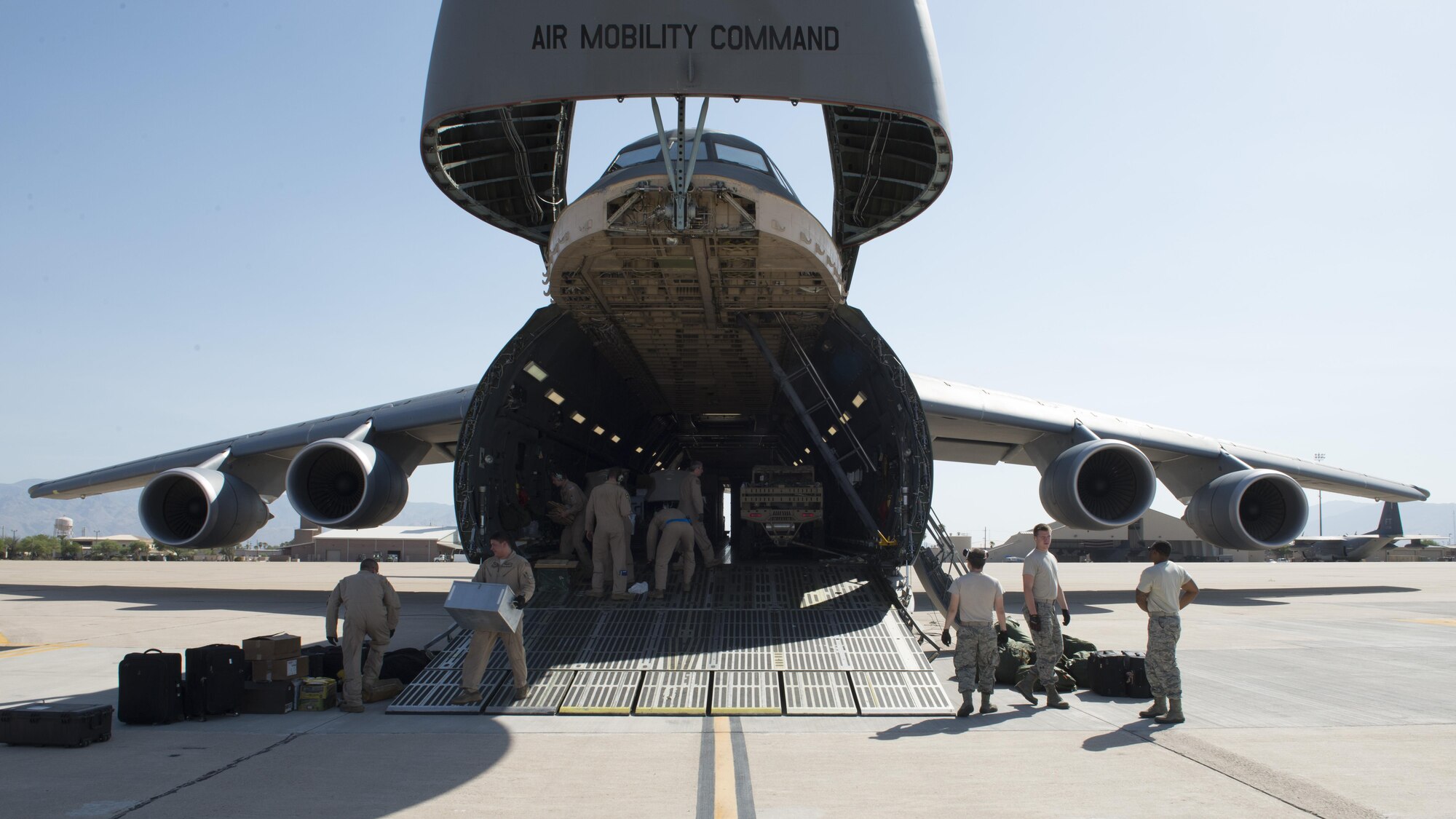 A C-5M Super Galaxy sits with its forward nose opened to allow an off-load of cargo June 2, 2016, at Davis-Monthan Air Force Base, Ariz. This C-5M delivered passengers and cargo from Camp Lemonnier, Djibouti to Davis-Monthan AFB. (U.S. Air Force photo/Senior Airman Zachary Cacicia)