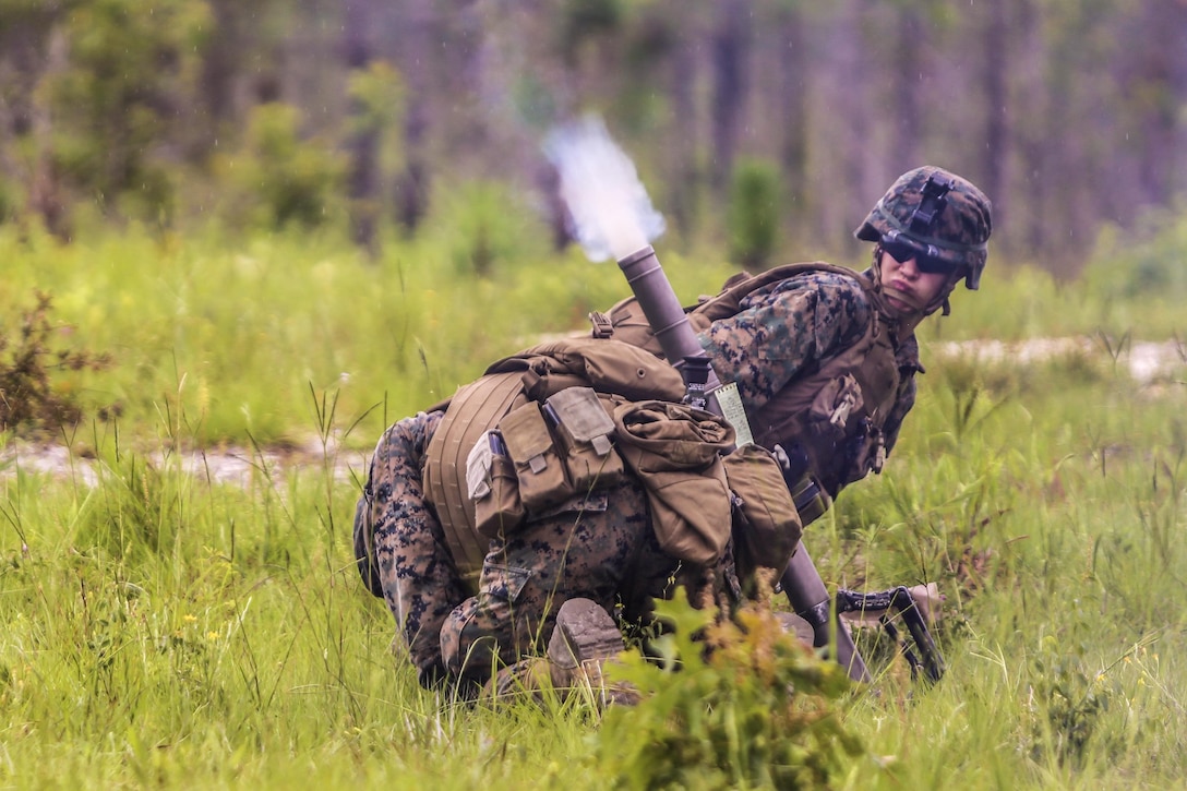 Marines take cover on the firing line as a mortar round shoots out of the barrel during a training exercise at Camp Lejeune, N.C., June 6, 2016. The Marines, assigned to 1st Battalion, 2nd Marine Regiment, took proficiency training to prepare for their upcoming deployment to support Special-Purpose Marine Air-Ground Task Force. Marine Corps photo by Lance Cpl. Aaron K. Fiala