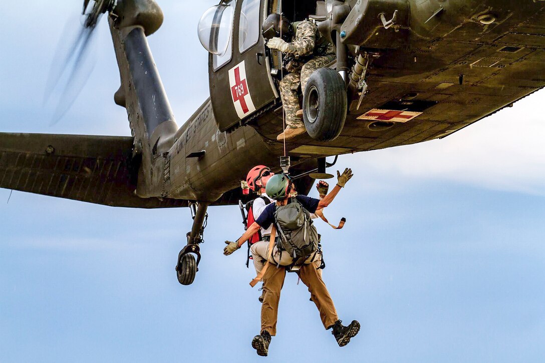 Soldiers conduct hoist training with civilian mountain rescue and law enforcement personnel in Yakima, Wash., June 7, 2016. The soldiers provide medical evacuation coverage for local mountain and wilderness areas in partnership with civilian authorities. Army photo by Capt. Brian H. Harris