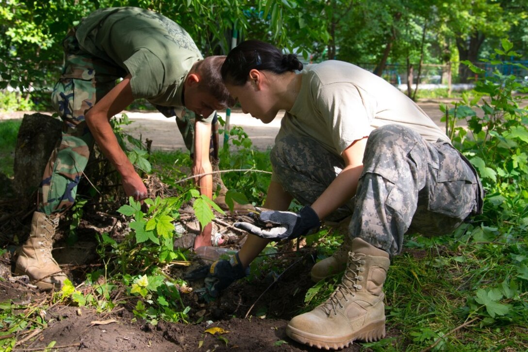 Maj. Kris Chow (right), assigned to the 457th Civil Affairs Battalion, 361st Affairs Brigade, 7th Civil Support Command, and a Moldovan Explosive Ordnance Disposal (EOD) engineer, remove concrete blocks from a playground, as part of a Humanitarian Civil Assistance (HCA) project, in Chisinau, Moldova, June 6, 2016. As part of the European Command’s (EUCOM) Humanitarian and Civic Assistance Program, the 123rd Civil Engineering Squadron from the Kentucky Air National Guard, 185th Engineering Squadron from Iowa Air National Guard, 457th Civil Affairs Battalion and Moldovan Land Forces collaborate to renovate to the kitchen at Special School Number 12 for Hearing Impaired Children and assist with renovations for the non-governmental organization La Via in Chisinau, Moldova, June 3-25, 2016. 