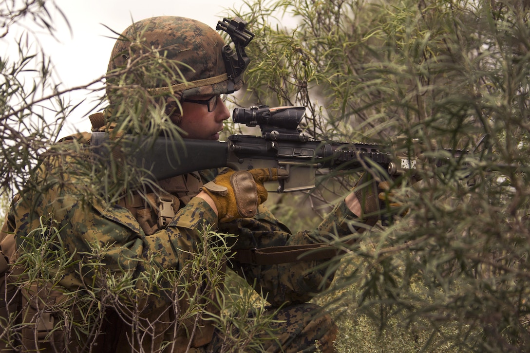 Marine Corps Pfc. Alexander L. Lay provides security while members of his team move between buildings during Exercise Predator Strike at Cultana Training Area, Australia, June 5, 2016. Lay is a rifleman assigned to Charlie Company, 1st Battalion, 1st Marine Regiment. Marine Corps photo by Cpl. Carlos Cruz Jr.