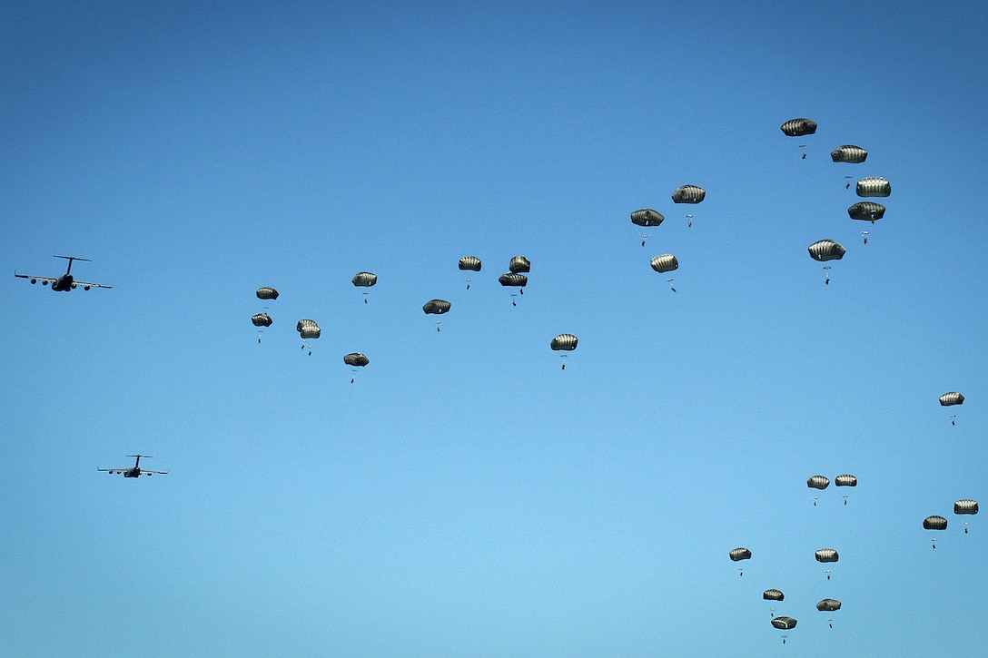 Paratroopers jump from an Air Force C-17 Globemaster aircraft during airborne operation, part of Swift Response 16 onto Torun drop zone in Poland, June 7, 2016. The paratroopers are assigned to the 82nd Airborne Division’s 1st Brigade Combat Team. The exercise is one of the premier military crisis response training events for multinational airborne forces in the world. It's designed to enhance U.S. Global Response Force readiness, currently the 82nd Airborne Division's 1st Brigade Combat Team, and more than 5,000 soldiers and airmen from NATO countries. Army photo by Sgt. Juan F. Jimenez