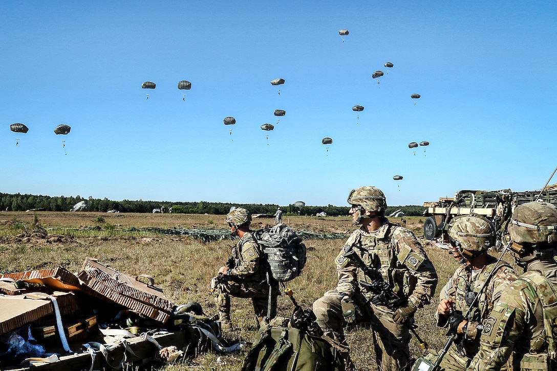 Paratroopers prepare for the next mission after a joint forceable airborne operation, part of Swift Response 16 at Torun drop zone in Poland, June 7, 2016. Army photo by Sgt. Juan F. Jimenez 
