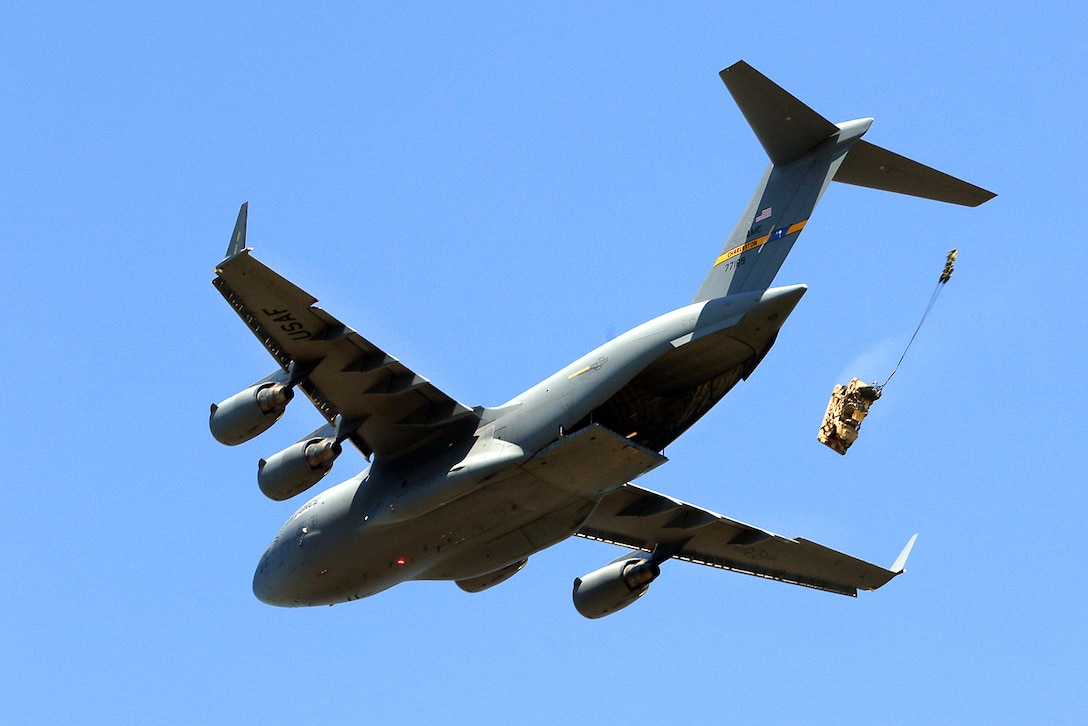 An Air Force C-17 Globemaster III aircraft drops a bundle of All-Terrain Vehicles during airborne operation, part of Swift Response 16 at Torun drop zone in Poland, June 7, 2016. Army photo by Sgt. Juan F. Jimenez