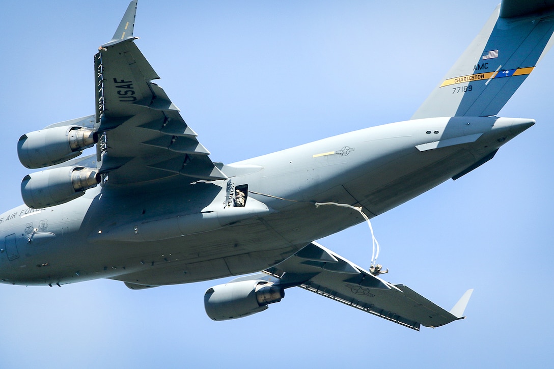 Paratroopers jump from Air Force C-17 Globemaster aircraft during airborne operation, part of Swift Response 16 onto Torun drop zone in Poland, June 7, 2016. Army photo by Sgt. Juan F. Jimenez