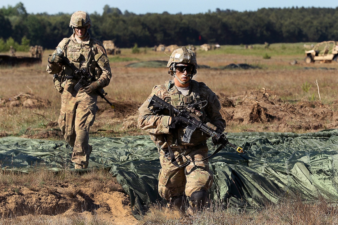 Paratroopers recover chutes and prepare to move out to the next objective after airborne operation, part of Swift Response 16 onto Torun drop zone in Torun, Poland, June 7, 2016. Army photo by Sgt. Juan F. Jimenez