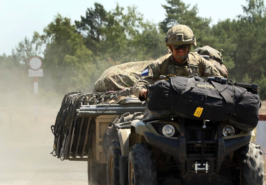 A British paratrooper rides an All-Terrain Vehicle to another objective after participating in a recon patrol with U.S. paratroopers during Swift Response 16 in Torun, Poland, June 8, 2016. Army photo by Sgt. Juan F. Jimenez