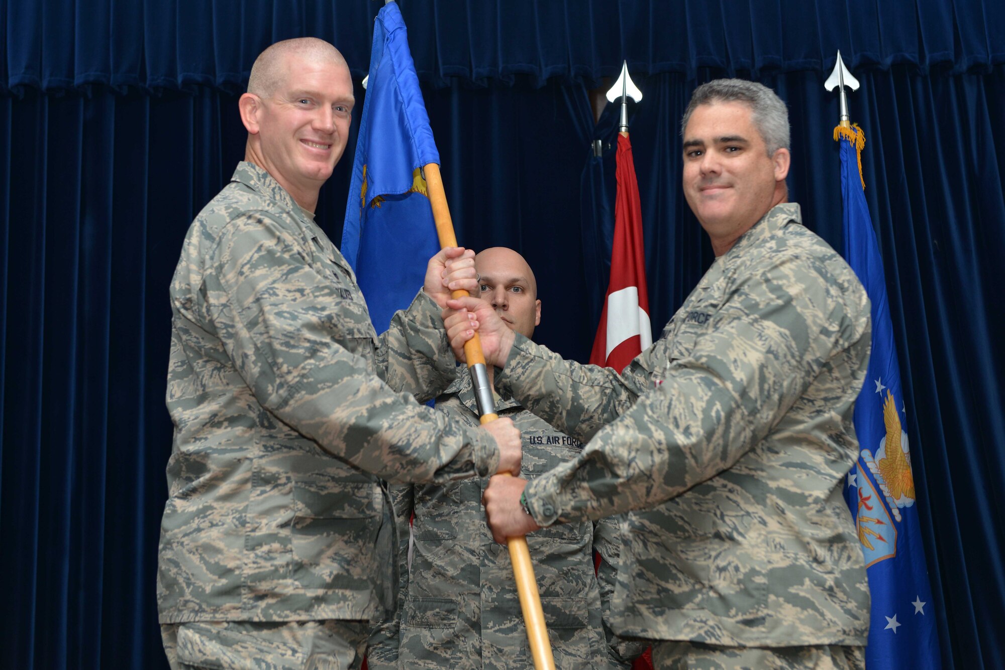 U.S. Air Force Lt. Col. Erin McDonald, 39th Communications Squadron outgoing commander, relinquishes command to U.S. Air Force Col. John Walker, 39th Air Base Wing commander, during a change of command ceremony June 14, 2016, at Incirlik Air Base, Turkey. McDonald’s next assignment will be at Fort Meade, Maryland. (U.S. Air Force photo by Senior Airman John Nieves Camacho/Released)