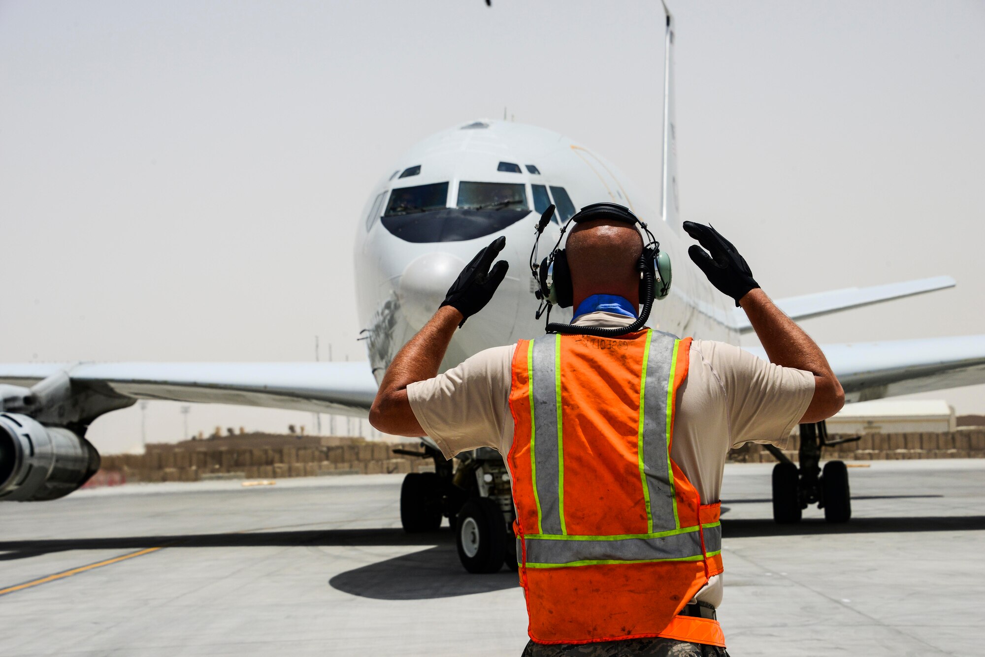 Staff Sgt. Brashears, 7th Expeditionary Air Mobility Unit crew chief, directs an E-8C Joint Surveillance Target Attack Radar Systems to its respective parking spot after completing a mission June 7, 2016. The JSTARS’ primary mission is to provide theater ground and air coalition commanders with ground surveillance to support attack operations and targeting that contributes to the delay, disruption and destruction of enemy forces. The aircraft is the only airborne platform in operation that can maintain real-time surveillance over a corps-sized area of the battlefield. (U.S. Air Force photo/Senior Airman Janelle Patiño/Released)