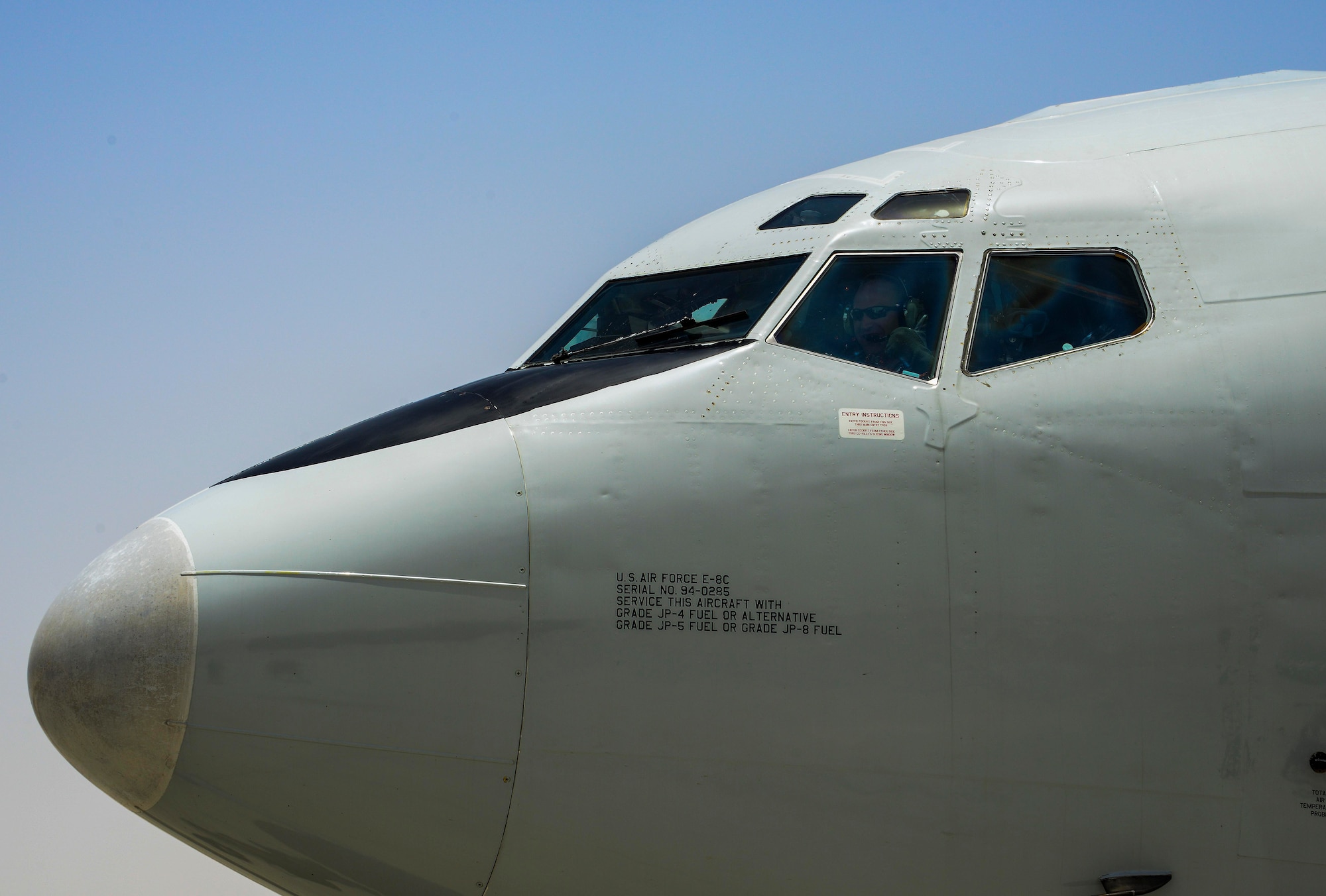 Maj. Daniel Hoak, 7th Expeditionary Airborne Command and Control Squadron joint surveillance target attack radar systems pilot, waves as he and his team taxi down the runway at Al Udeid Air Base, Qatar, after returning from a mission June 7, 2016. The E-8C JSTARS is a joint U.S. Air Force and U.S. Army program that detects, tracks and classifies moving ground vehicles in all conditions deep behind enemy lines by using a multi-mode side looking radar. The system evolved from Army and Air Force programs to develop, detect, locate and attack enemy armor at ranges beyond the forward area of troops. (U.S. Air Force photo/Senior Airman Janelle Patiño/Released)