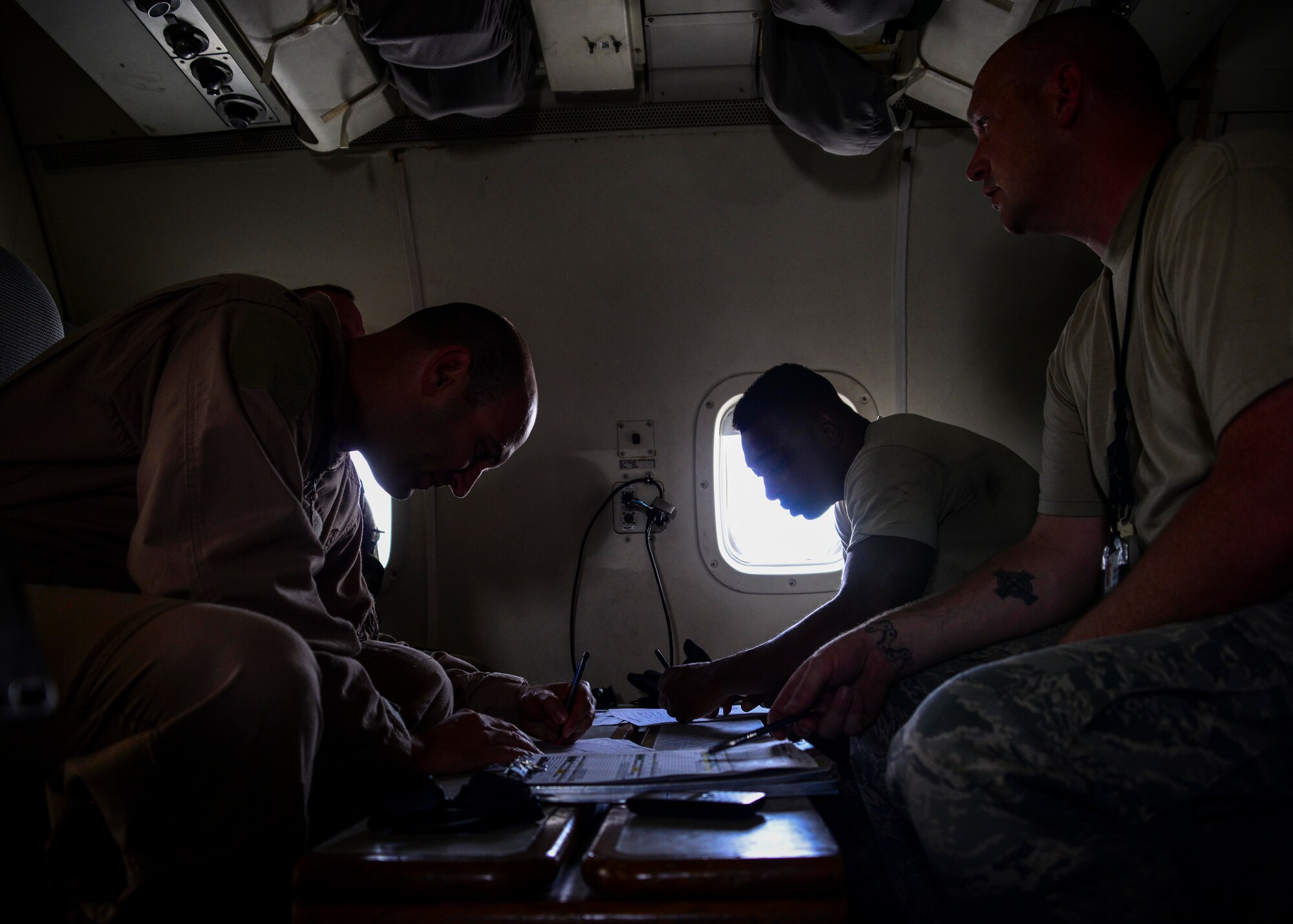 Joint Surveillance Target Attack Radar Systems aircrew and 7th Expeditionary Air Mobility Unit maintenance Airmen conduct a post-flight maintenance debrief June 7, 2016, at Al Udeid Air Base, Qatar. The E-8C JSTARS and its active duty, guard and reserve service members conduct missions overseas to support operations on the war on terror. (U.S. Air Force photo/Senior Airman Janelle Patiño/Released)