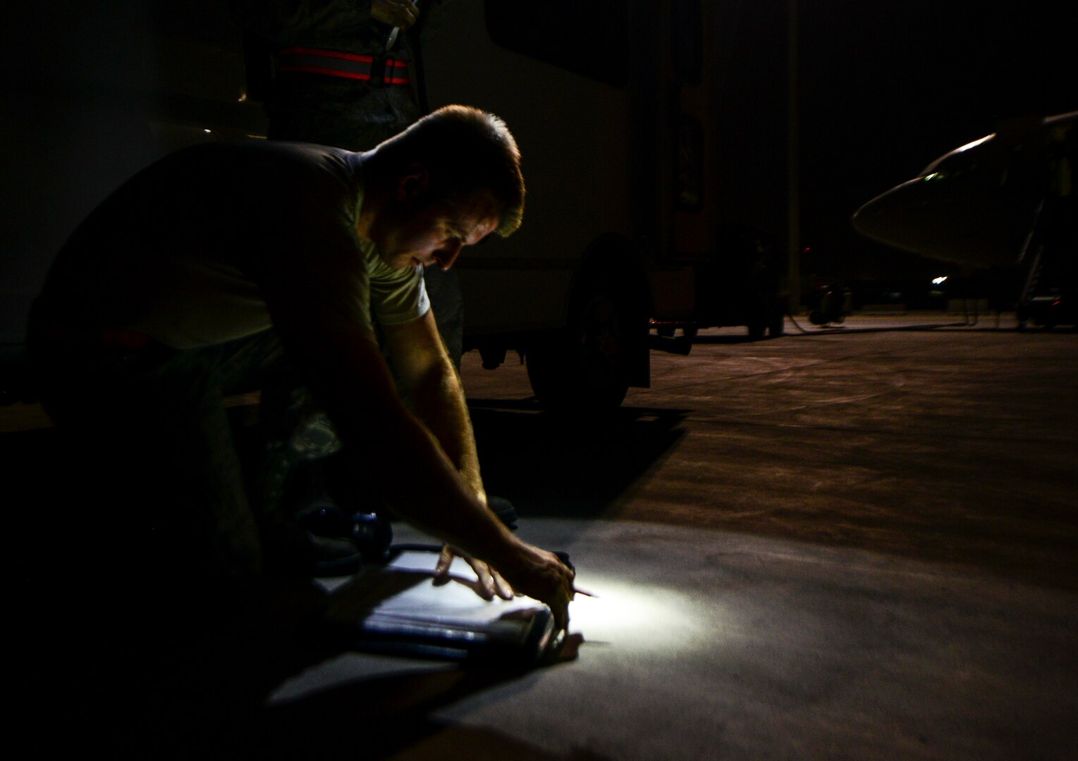 Staff Sgt. Eddy, 7th Expeditionary Air Mobility Unit hydraulic specialist, annotates maintenance actions performed during an E-8C Joint Surveillance Target Attack Radar Systems inspection prior to aircrew arrival June 8, 2016, at Al Udeid Air Base, Qatar. JSTARS fly daily at various times and average around 11 hours per flight to support operations on the war on terror. (U.S. Air Force photo/Senior Airman Janelle Patiño/Released)