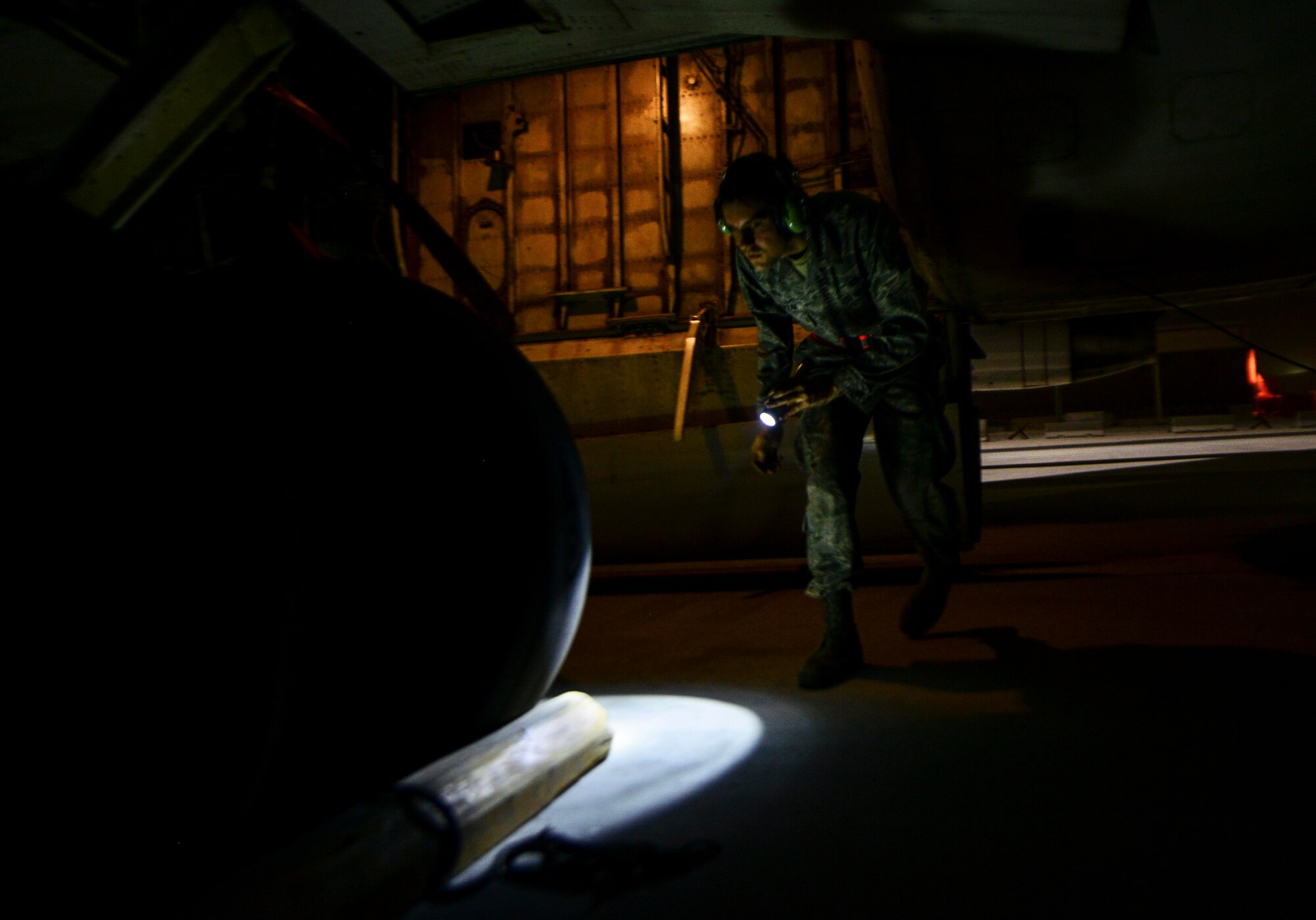 Staff Sgt. Balcerzak, 7th Air Mobility Unit crew chief, inspects the tires of an E-8C Joint Surveillance Target Attack Radar Systems prior to aircrew arrival June 8, 2016, at Al Udeid Air Base, Qatar. The 7th Expeditionary Airborne Command and Control Squadron and 7th AMU work alongside each other to check the aircraft for hazards, chalk the tires and ensure the pilots can exit the flight line safely. (U.S. Air Force photo/Senior Airman Janelle Patiño/Released)