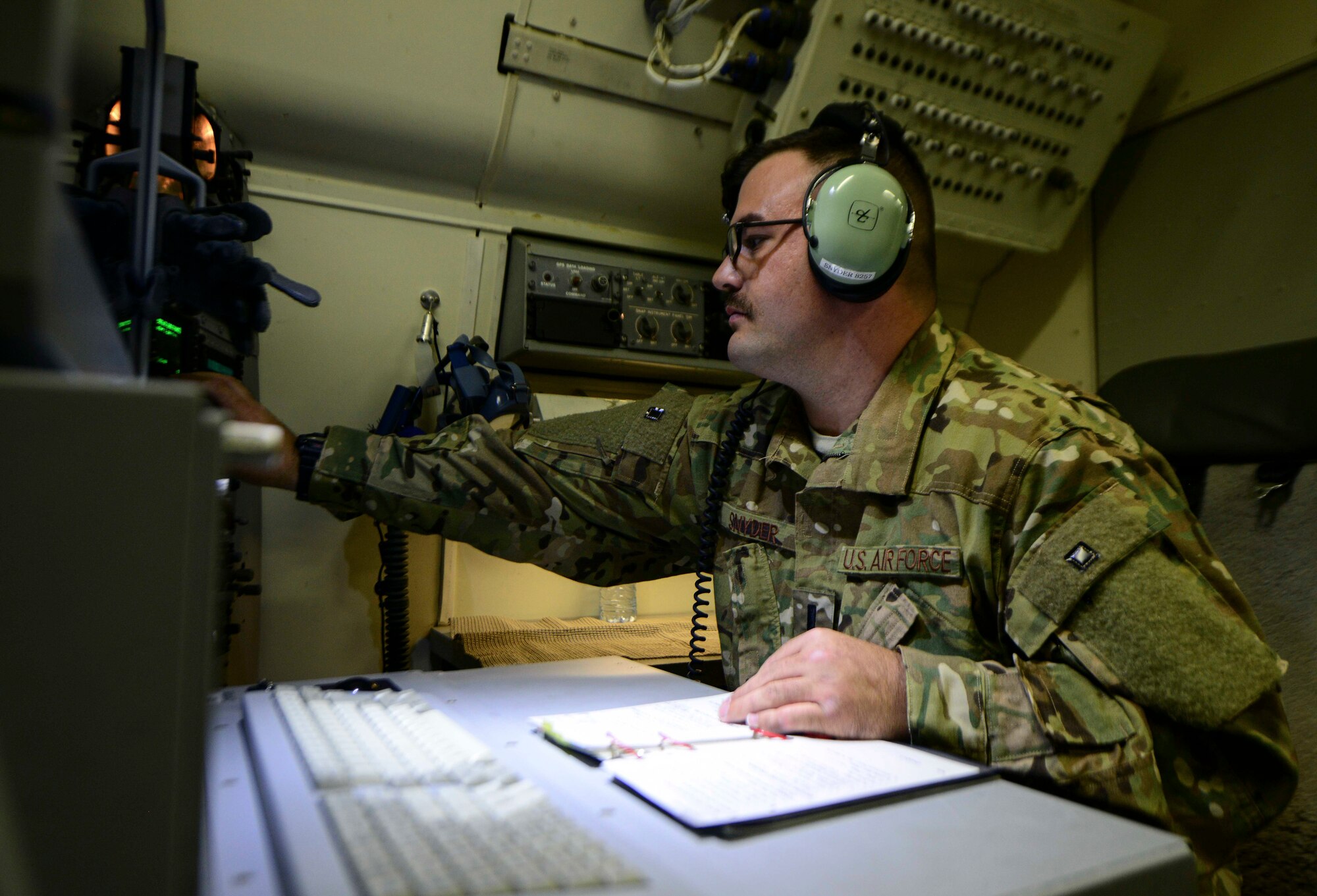 1st Lt. Cory Snyder, 7th Expeditionary Airborne Command and Control Squadron joint surveillance target attack radar systems navigator sets up computer systems in an E-8C JSTARS prior to takeoff June 8, 2016, at Al Udeid Air Base, Qatar. JSTARS aircrew report the information they collect to theater ground and air commanders to ensure coalition forces have real-time data in support of operations on the war on terror. (U.S. Air Force photo/Senior Airman Janelle Patiño/Released)