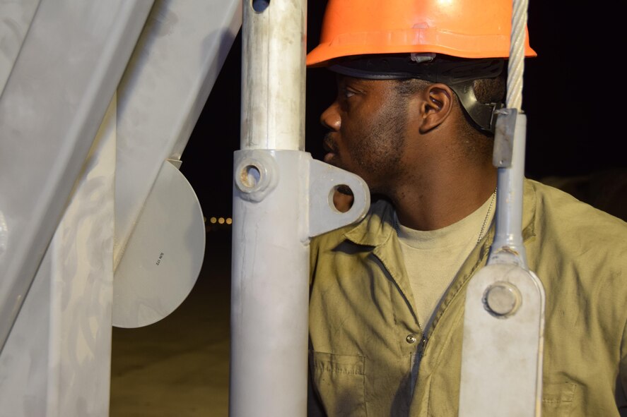 Senior Airman Joshua Duncan, 379th Expeditionary Aircraft Maintenance Squadron crew chief, operates a hoist June 2, 2016, at Al Udeid Air Base, Qatar, as his team installs an engine cowl on a B-52 Stratofortress. The aircraft and its air and maintenance crews are deployed in support of operations throughout the region. (U.S. Air Force photo/Technical Sgt. Carlos J. Treviño/Released)