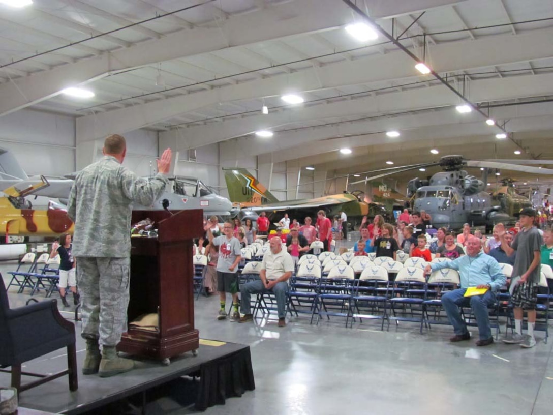 Defense Logistics Agency Aviation Industrial Support Activity Site Commander at Ogden, Utah, Air Force Col. Dan Lockert, lead’s children in reciting the federal oath of office during the organization’s “Bring Your Child to Work Day” Jun. 9, 2016 at the Hill Aerospace Museum on Hill Air Force Base. 