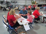 Children identify parts that have problems during Defense Logistics Agency Aviation at Ogden, Utah’s “Bring Your Child to Work Day” Jun. 9, 2016 held at the Hill Aerospace Museum on Hill Air Force Base. 