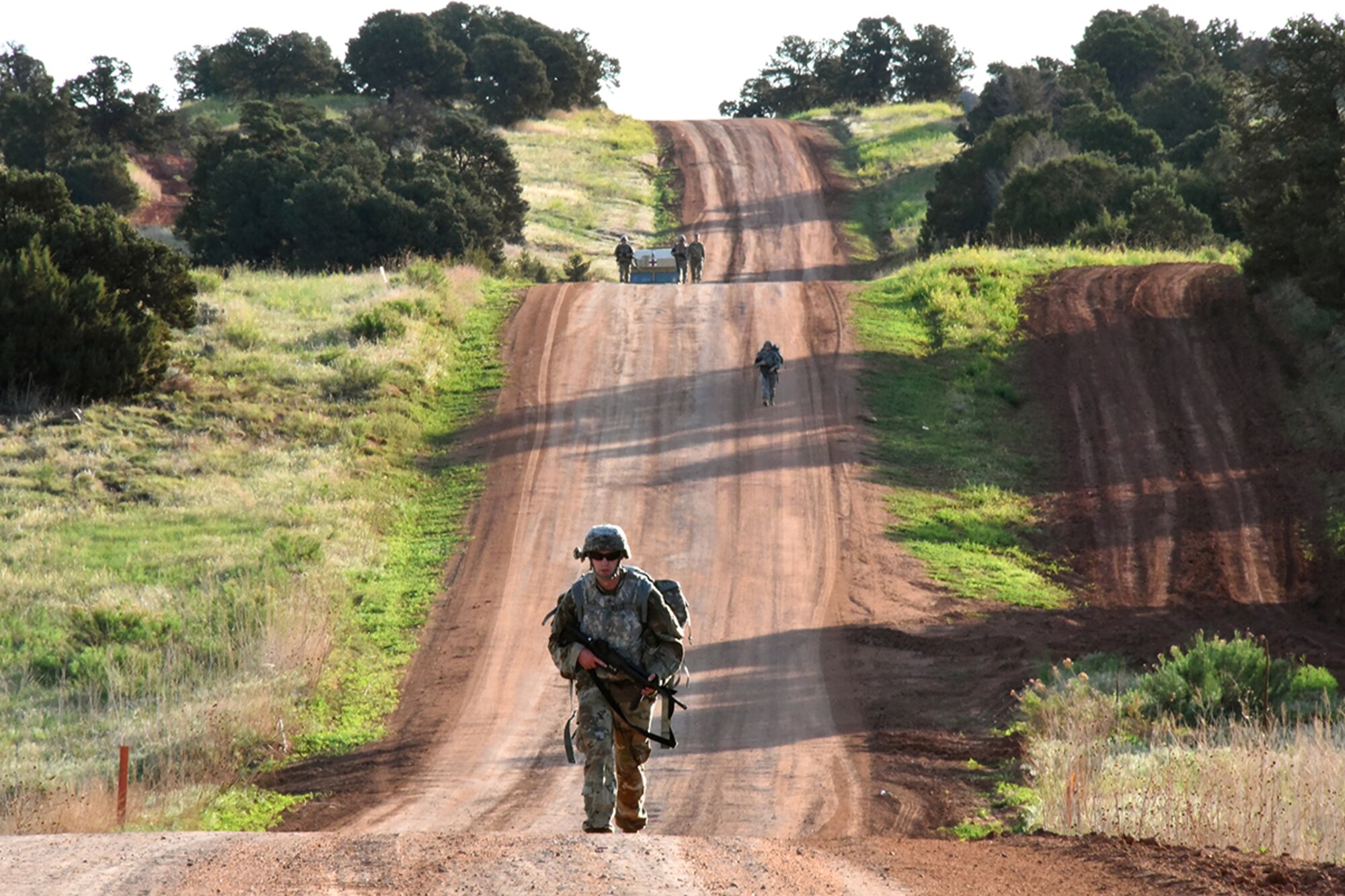 FORT CARSON, Colo. - Sgt. Randy Phillips, Company C, 53rd Signal Battalion, followed by three other competitors completes the 12-mile ruck march with a 45-pound ruck plus gear during the U.S. Army Space and Missile Defense Command/Army Forces Strategic Command’s Best Warrior Competition June 7 at Fort Carson, Colorado. (Photo by Carrie E. David SMDC/ARSTRAT)