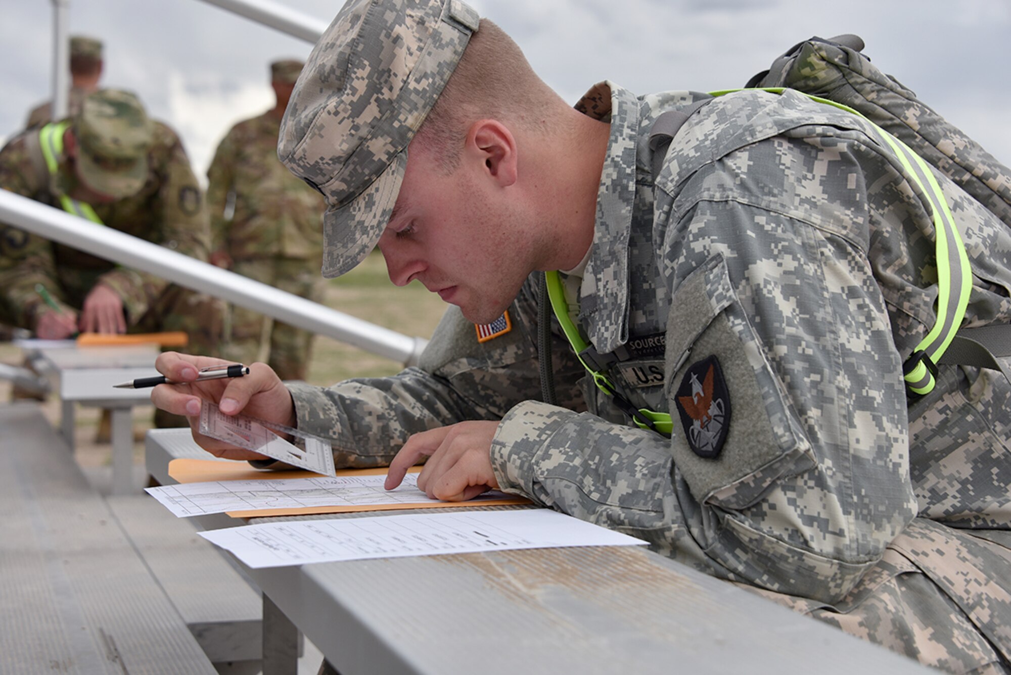 FORT CARSON, Colo. - Spc. Devon Lenz, Company B, 53rd Signal Battalion, plots points during the day land navigation portion of the U.S. Army Space and Missile Defense Command/Army Forces Strategic Command’s Best Warrior Competition June 6 at Fort Carson, Colorado. (Photo by Dottie K. White SMDC/ARSTRAT)