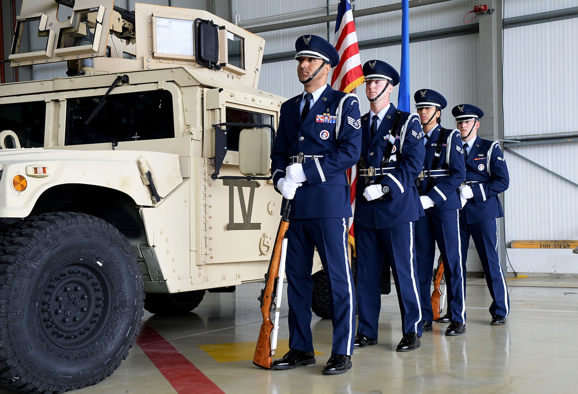 U.S. Air Force base honor guardsmen prepare to present the colors at a change of command ceremony June 10, 2016, on RAF Mildenhall, England. These teams generally consist of four individuals: the two outermost are rifle guards and serve as protectors of the colors, which are carried by the two individuals in the middle. (U.S. Air Force photo by Airman 1st Class Tenley Long/Released)