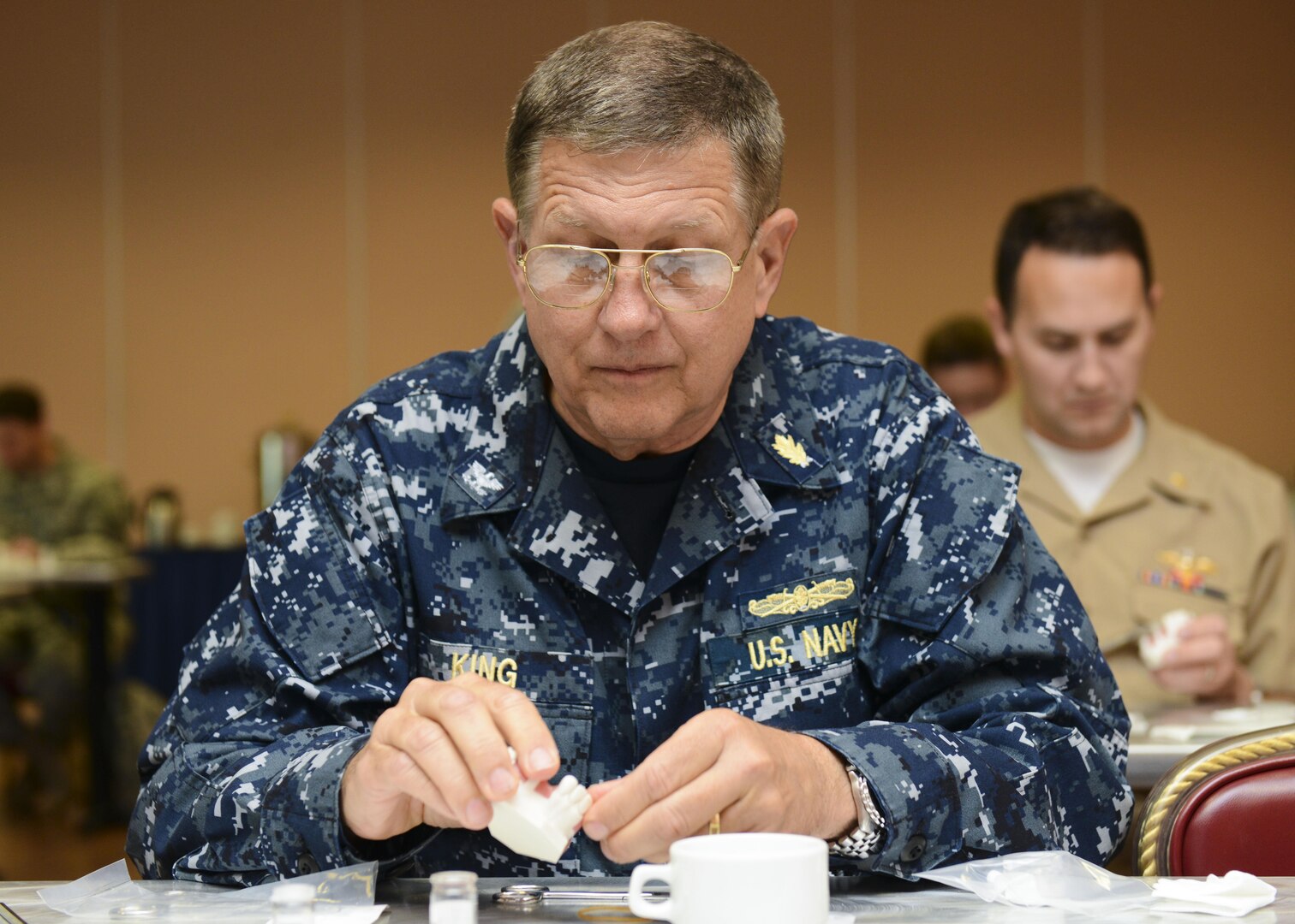 U.S. Navy Capt. Philip King, U.S. Naval Hospital Naples, Italy periodontist, manipulates dental putty during a periodontics symposium, June 10, 2016, at Aviano Air Base, Italy. This year’s symposium was the first to host U.S. Navy dental practitioners. (U.S. Air Force photo by Senior Airman Austin Harvill/Released)