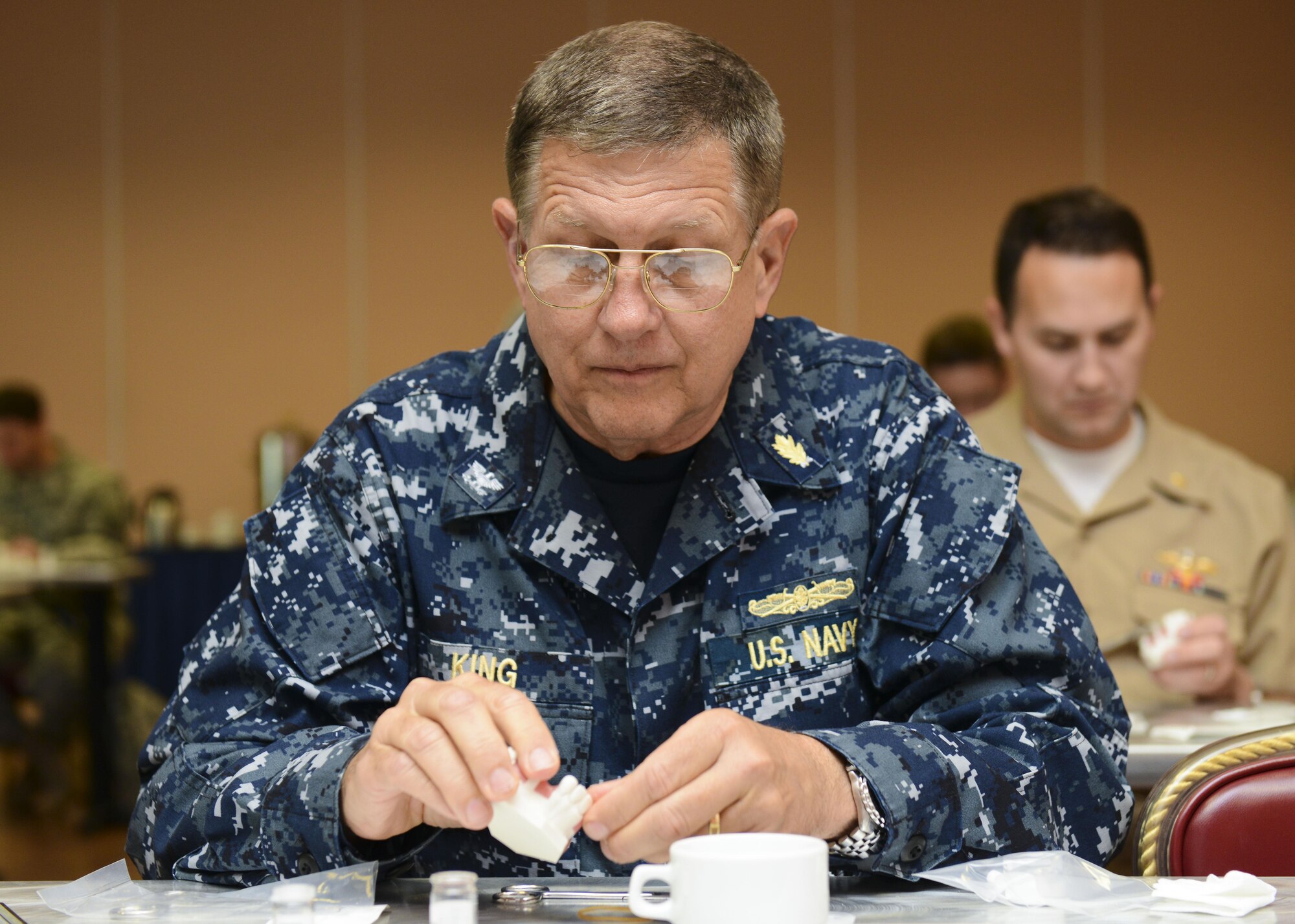 U.S. Navy Capt. Philip King, U.S. Naval Hospital Naples, Italy periodontist, manipulates dental putty during a periodontics symposium, June 10, 2016, at Aviano Air Base, Italy. This year’s symposium was the first to host U.S. Navy dental practitioners. (U.S. Air Force photo by Senior Airman Austin Harvill/Released)