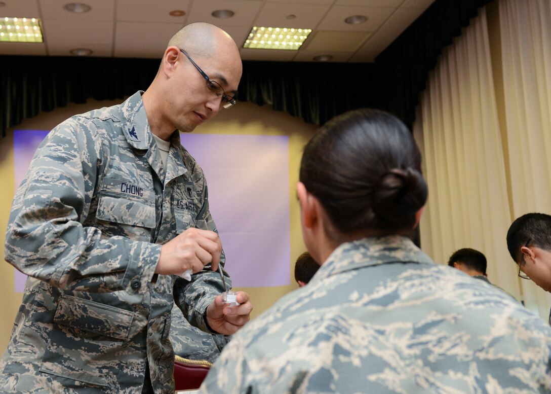 Colonel Chol Chong, U.S. Air Force Surgeon General military consultant in periodontics, demonstrates a dental filling technique during a periodontics symposium, June 10, 2016, at Aviano Air Base, Italy. Chong, the event’s guest speaker, discussed a range of periodontics topics to 31 attendees comprised of U.S. Air Force, U.S. Army and, for the first time, U.S. Navy periodontics specialists, as well as local Italian dentists. (U.S. Air Force photo by Senior Airman Austin Harvill/Released)