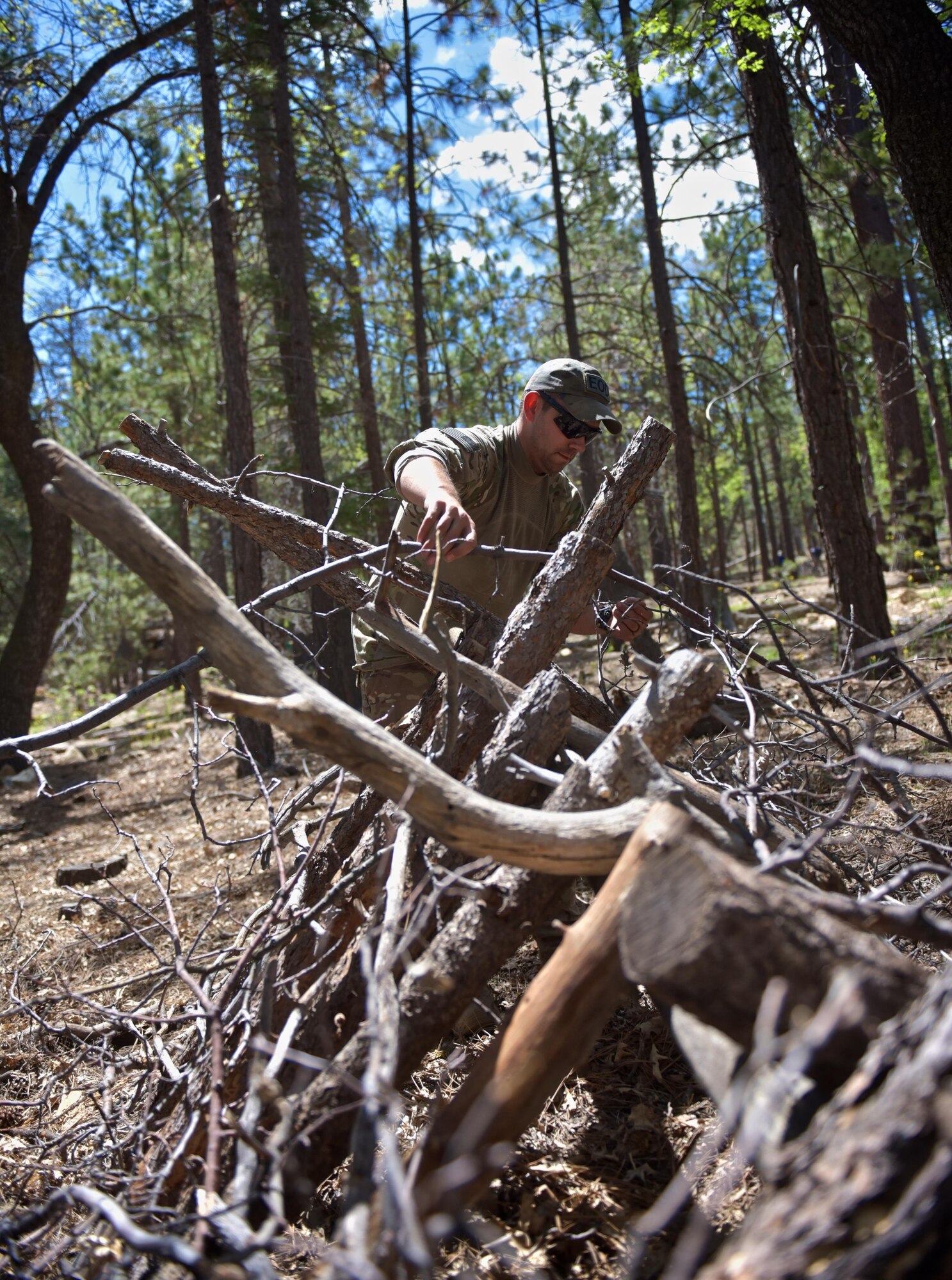 Staff Sgt. Christopher Priddy, member of the the 932nd Airlift Wing explosive ordnance disposal team works on his A-frame shelter during a week long survival course in the San Bernardino mountains, June 1, 2016, Angelus Oaks, California.  The 932nd AW EOD team attended the course to learn basic survival skills that might help if ever stranded during a deployment or training exercise. 
(U.S. Air Force photo by Tech. Sgt. Christopher Parr)