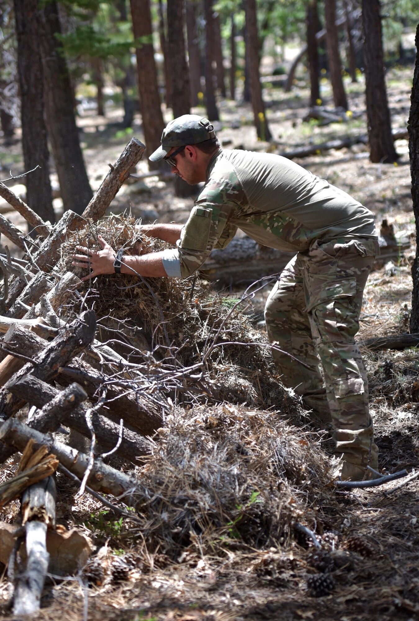 Staff Sgt. Christopher Priddy, member of the the 932nd Airlift Wing explosive ordnance disposal team works on his A-frame shelter during a week long survival course in the San Bernardino mountains, June 1, 2016, Angelus Oaks, California.  The 932nd AW EOD team attended the course to learn basic survival skills that might help if ever stranded during a deployment or training exercise. 
(U.S. Air Force photo by Tech. Sgt. Christopher Parr)