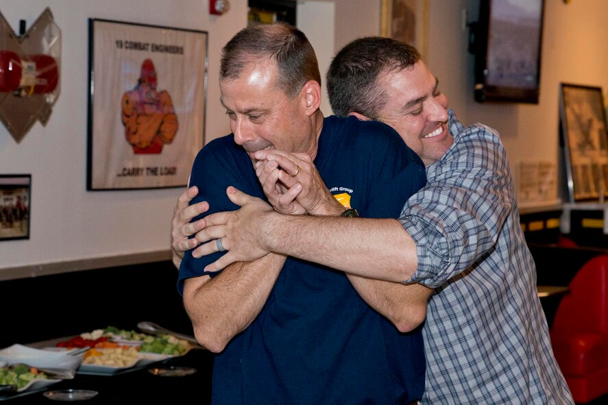 U.S. Air Force Reserve Col. Craig Drescher, commander, 913th Airlift Group, receives a bear hug from U.S. Air Force Reserve 1st Lt. John Sessoms, former executive officer, 913th Airlift Group, during a farewell tribute at Little Rock Air Force Base, Ark., June 11, 2016. Drescher is leaving the 913th AG to take a position at Air Force Reserve Command Headquarters at Robins Air Force Base, Ga. (U.S. Air Force photo by Master Sgt. Jeff Walston/Released)