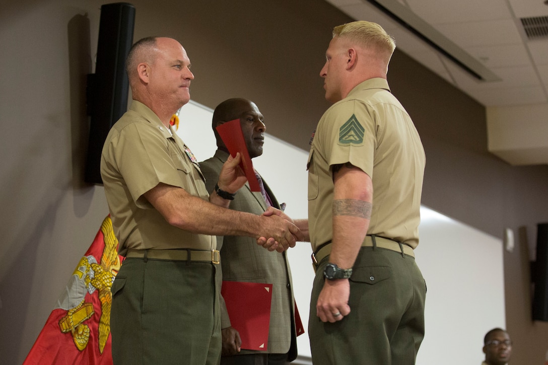 Marine Corps Base Camp Pendleton, Calif. – Staff Sgt. Sean Fordham, the chemical, biological, radiological, neurological chief for the 11th Marine Expeditionary Unit, receives a graduation certificate from Col. Ian R. Clark, commanding officer of Marine Corps Air Station Camp Pendleton, after the first annual year class of Career Course Seminar on Camp Pendleton May 26, 2016. Career Course Seminar provides the skills necessary for a staff sergeant to act as a problem solver, lead at a platoon level, mentor company-grade officers and lead and develop subordinate leaders. (U.S. Marine Corps photo by Sgt. Tony Simmons/Released)