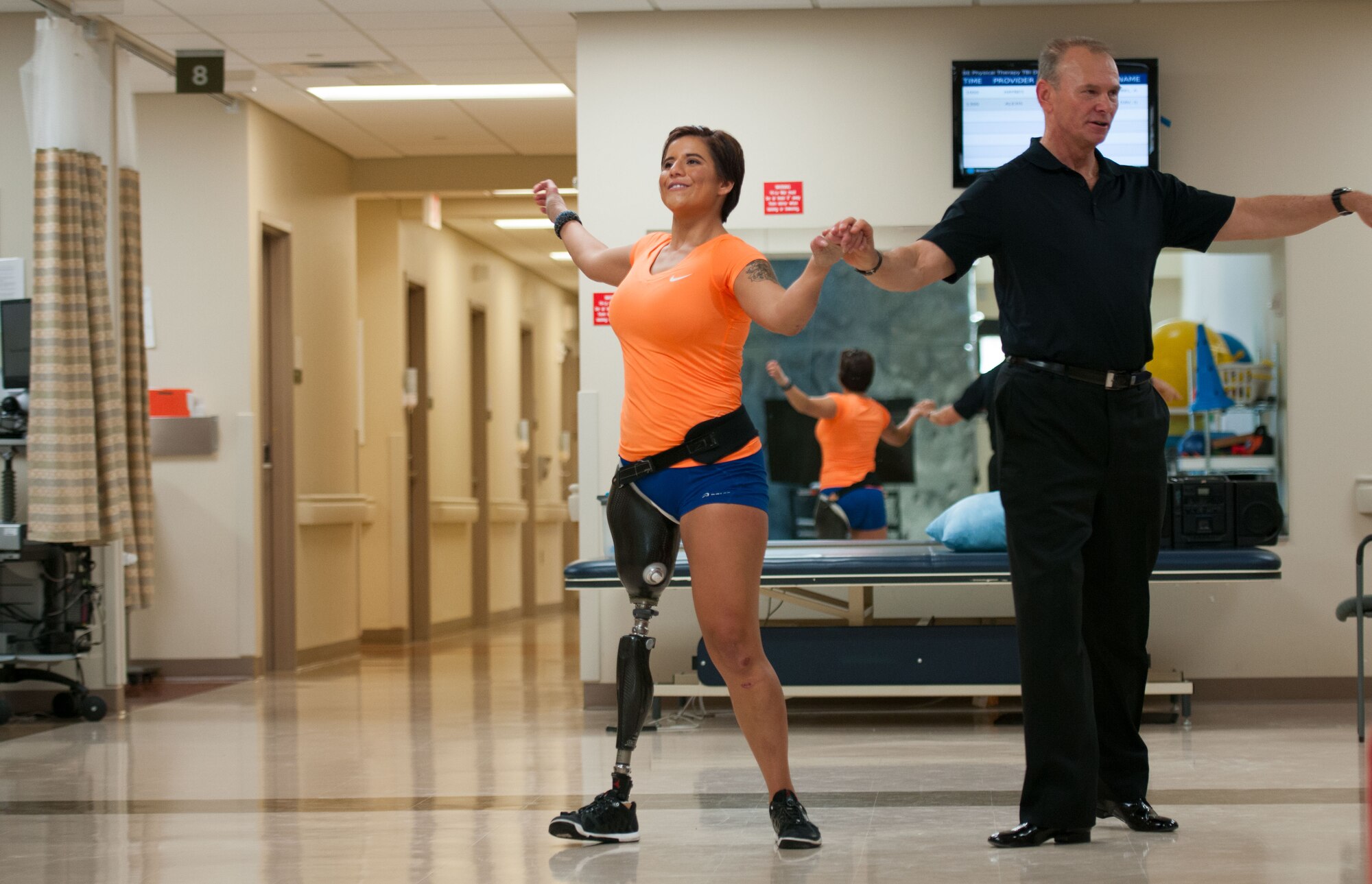 Staff Sgt. Sebastiana Lopez Arellano, a patient at Walter Reed National Military Medical Center in Bethesda, Md., learns some dance moves from volunteer Joe Kiballa on April 16, 2016. Lopez lost her right leg and suffered several other injuries in a motorcycle crash in 2015. She now uses sports and fitness as part of her physical and occupational therapy regimen. (U.S. Air Force photo/Sean Kimmons)