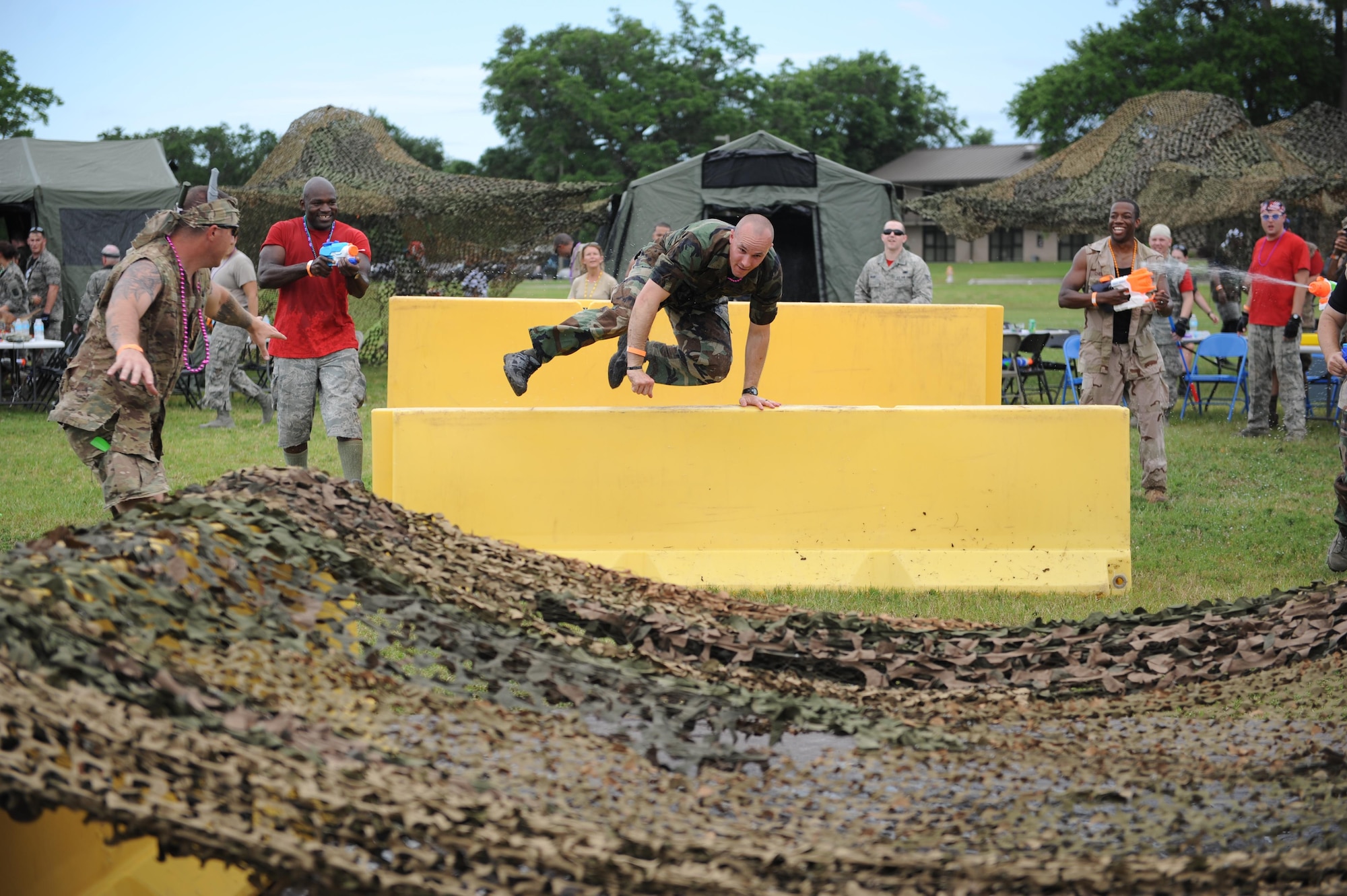 Capt. Harlan Glinski, 81st Security Forces Squadron operations officer, jumps over barriers during the 81st Mission Support Group Combat Dining In June 10, 2016, Keesler Air Force Base, Miss. The Combat Dining-In is a military tradition that promotes camaraderie and esprit de corps throughout the ranks. (U.S. Air Force photo by Kemberly Groue)