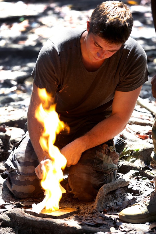 A French army sergeant assigned to the jungle warfare school in Gabon lights gunpowder during a survival class at the school, June 6, 2016. Army photo by Sgt. Henrique Luiz de Holleben