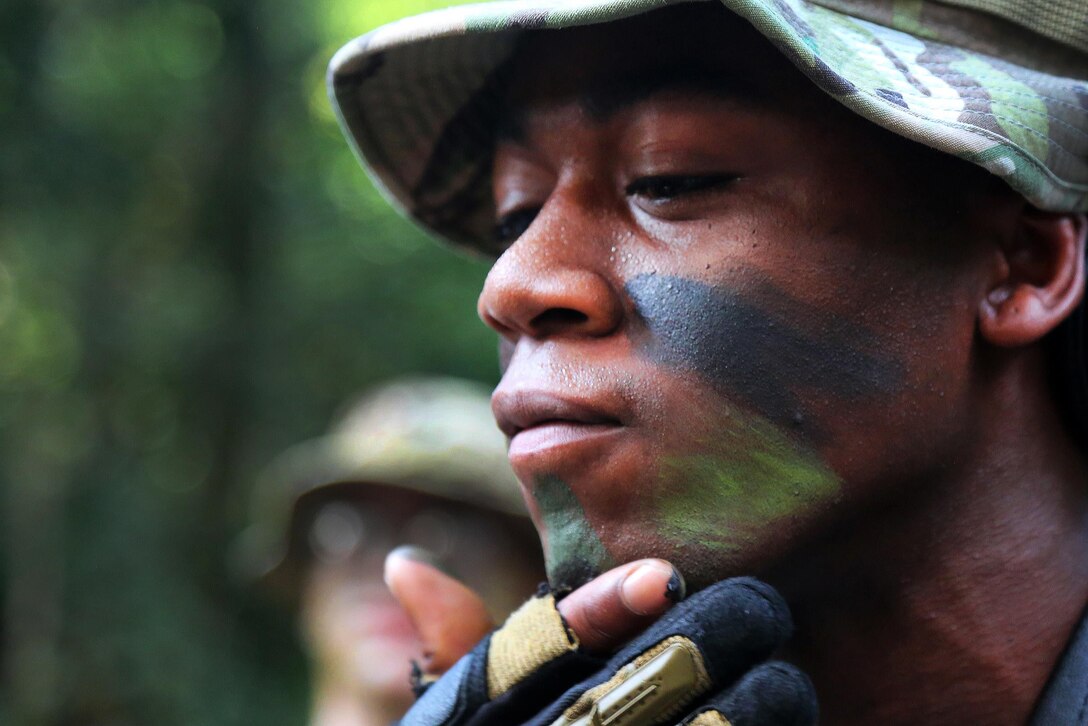 U.S Army Pfc. Deven Waller applies face paint before participating in training at the French jungle warfare school in Gabon, June 6, 2016. Waller, a photographer assigned to 55th Signal Company (Combat Camera), is helping to document the training as part of Central Accord 16. Army photo by Spc. Yvette Zabala-Garriga