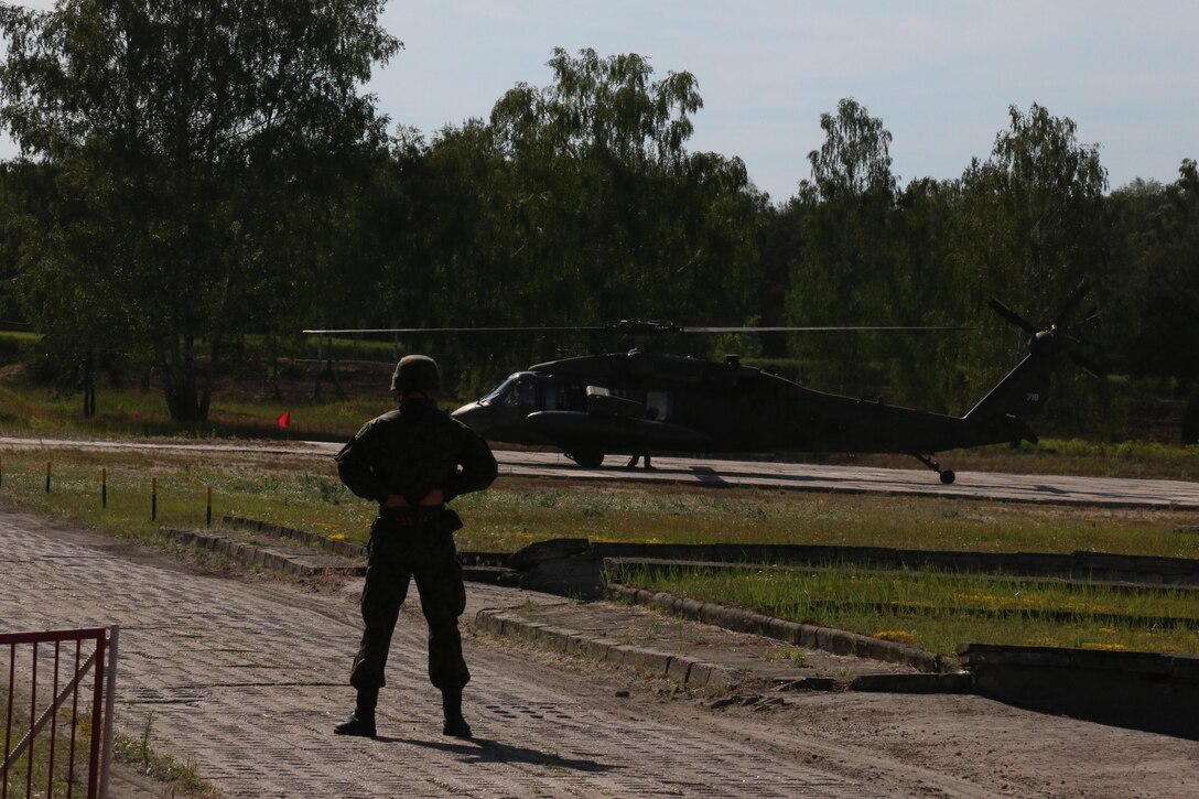 A U.S. Army aviation crew from the 1-214th Aviation Regiment, Alpha Company, Wiesbaden, Germany, prepares to pick up U.S. and Polish Soldiers during Anakonda 16 on a Polish base outside Warsaw, Poland June 12. Anakonda 16 is a Polish-led national event that seeks to train, exercise and integrate Polish national command and force structures into an Allied, joint, multinational environment. (Photo by Capt. A. Sean Taylor, 649th RSG)