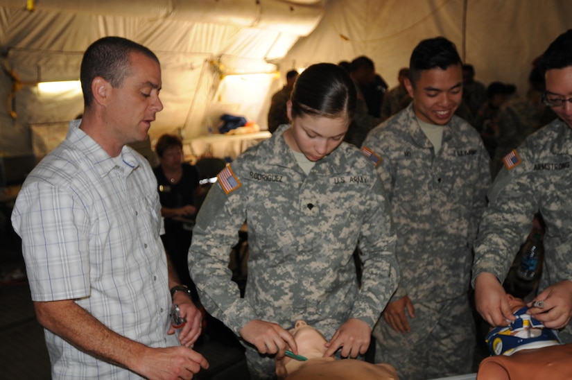Ted Langevin, a volunteer with CALSTAR, teaches 2nd Medical Brigade Soldier Spc. Jasmaine Rodriguez, A 92G food service specialist From Chico California, the proper method for surgical cricothyrotomy during the annual training exercise at Camp Parks, Calif.  Big Logistics Over-The-Shore, West is an annual, Army Reserve, multi-echelon functional exercise designed for transportation units and sustainment commands to hone their expertise in Logistics Over-the-Shore (LOTS) operations from June 10 to June 24, 2016.  Big LOTS West is a multi-component exercise involving elements from the Active Component Army, U.S. Navy, U.S. Air Force, U.S. Coast Guard, and U.S. Maritime Administration are conducting operations at three Bay-Area California training locations: Camp Parks, Alameda Point, and Coast Guard Island.